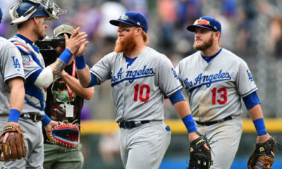 Jun 3, 2018; Denver, CO, USA; Los Angeles Dodgers catcher Yasmani Grandal (9), third baseman Justin Turner (10) and first baseman Max Muncy (13) celebrate the win over the Colorado Rockies at Coors Field. Mandatory Credit: Ron Chenoy-USA TODAY Sports
