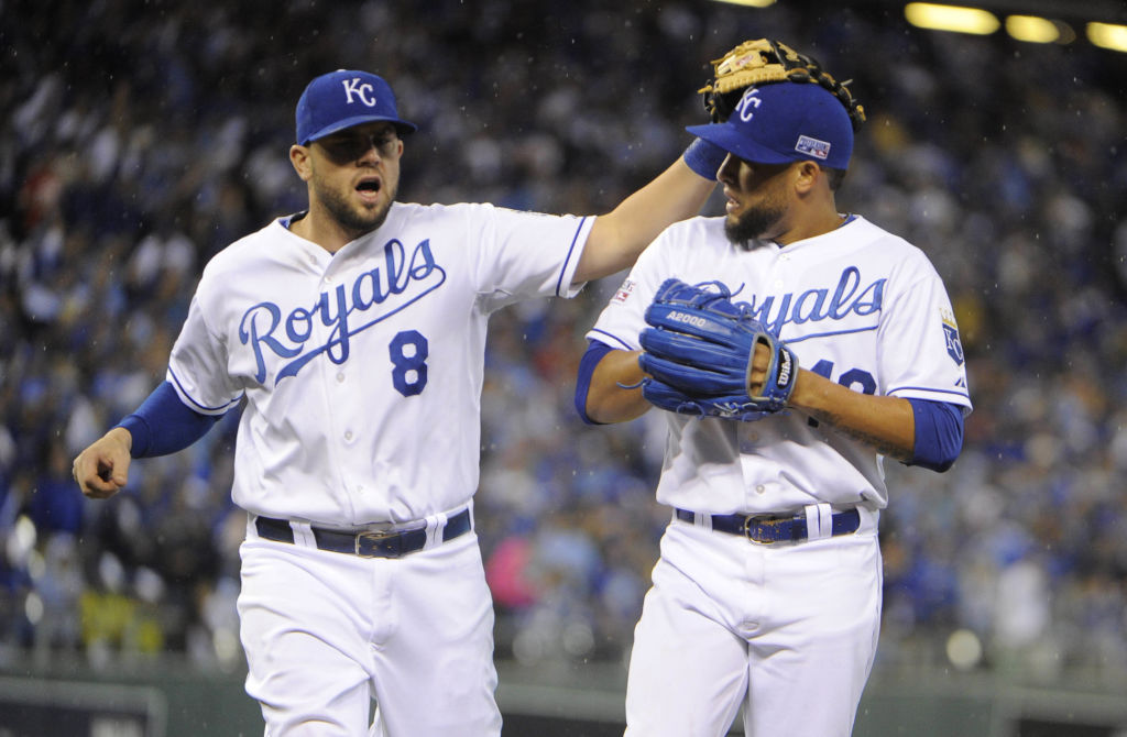 Oct 5, 2014; Kansas City, MO, USA; Kansas City Royals third baseman Mike Moustakas (8) congratulates relief pitcher Kelvin Herrera (40) in the seventh inning of game three of the 2014 ALDS baseball playoff game at Kauffman Stadium. The Royals won 8-3 advancing to the ALCS against the Baltimore Orioles. Mandatory Credit: John Rieger-USA TODAY Sports